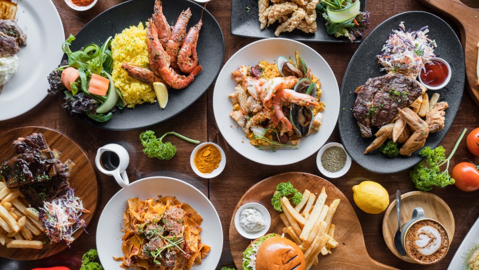 File: Different dishes of food spread on table. GettyImages/nazar_ab