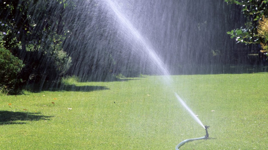 File: A lawn being watered with a hosepipe. Biosphoto via AFP/Frederic Didillon