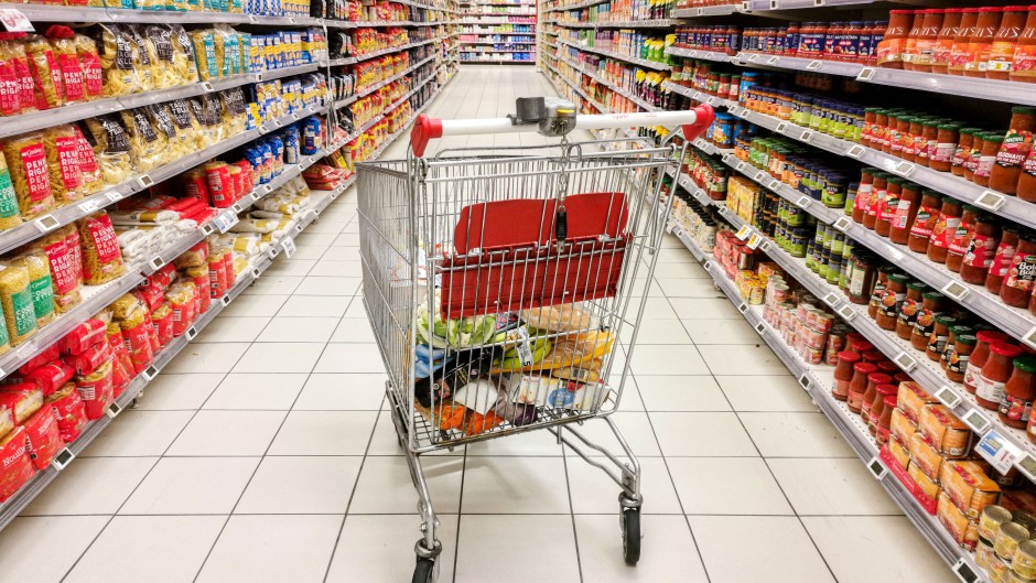File: A shopping cart in the middle of a section of canned and dried products. Nicolas Guyonnet/Hans Lucas via AFP