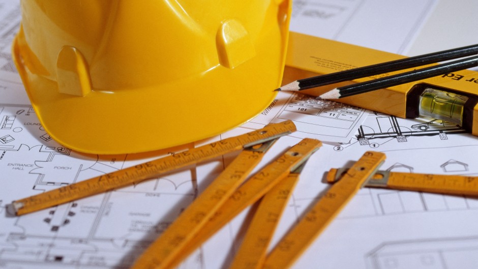 File: Hard hat and architectural blueprints.
