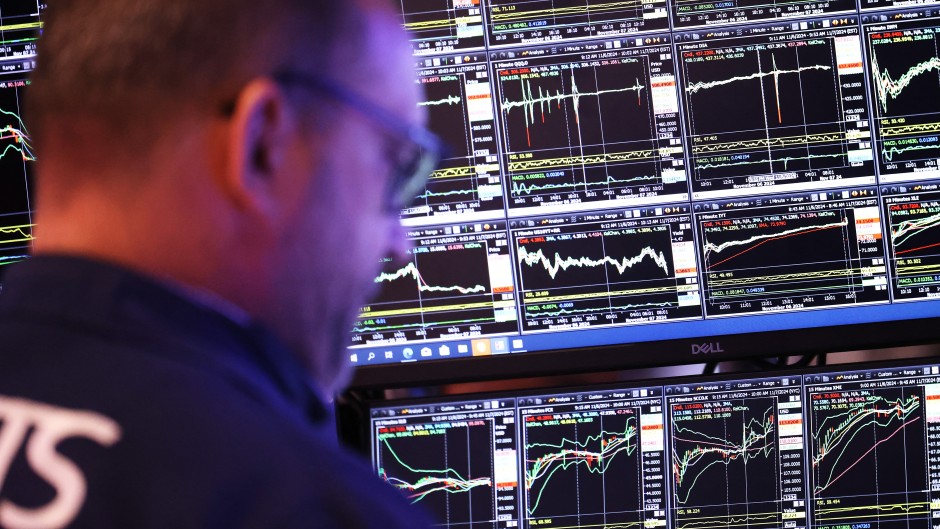 Traders work on the floor of the NYSE during the morning trading. Michael M. Santiago/Getty Images/AFP
