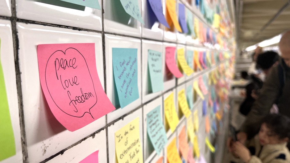 People leave post-it notes as they take part of the Subway Therapy project. AFP/Diane Desobeau