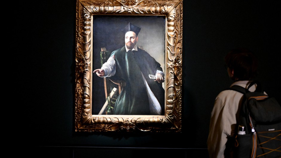 A visitor looks at the private collection by Italian master Caravaggio. AFP/Alberto Pizzoli