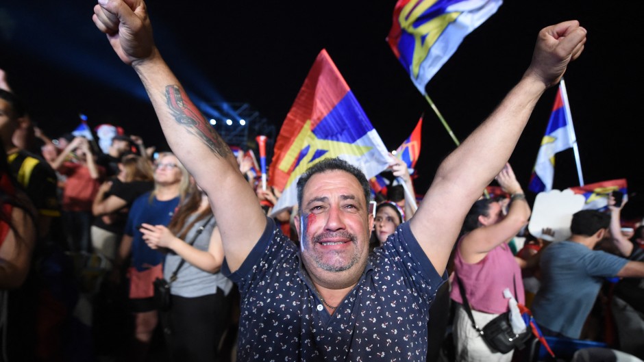 A supporter of Uruguay's president-elect, Yamandu Orsi, of the Frente Amplio coalition, celebrates after the presidential runoff election in Montevideo. AFP/Dante Fernandez