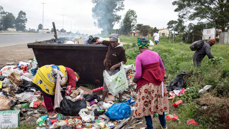 Women look for recyclable items in a garbage container on the streets in Mthatha. Per-Anders Pettersson/Getty Images