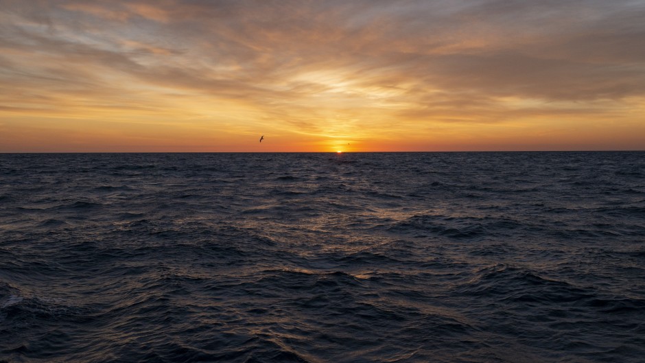 File: The sun rises over the Atlantic Ocean.