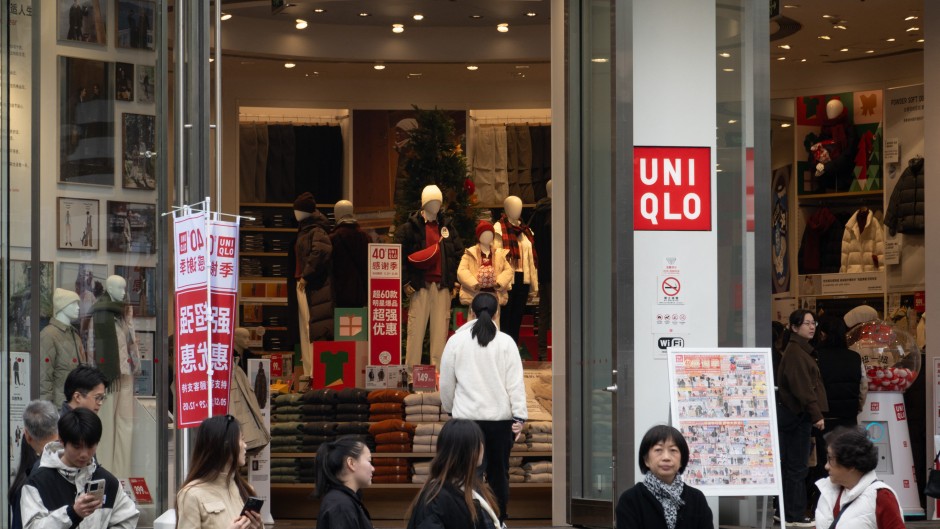 Customers pass by Uniqlo's global flagship store in Shanghai, China. CFOTO/NurPhoto via AFP
