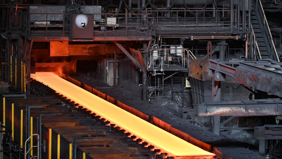 File: Steel moving along rollers at the hot rolling mill. AFP/Richard A. Brooks