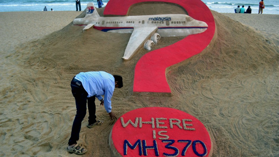 File:  Indian sand artist Sudarsan Pattnaik creating a sand sculpture of the missing Malaysia Airlines flight MH370 on Puri beach. AFP/J .K. Jagdev