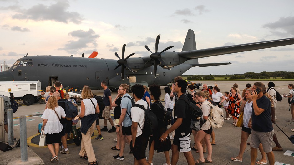 Australian Defence Force personnel assisting Australians off a C-130J Hercules at Brisbane Airport following an earthquake which struck Port Vila, Vanuatu. AFP/Adam Abela/DFAT
