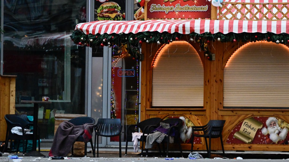 Empty chairs with abandoned blankets and debris are seen at a closed Christmas market where a car crashed into a crowd. AFP/John MacDougall