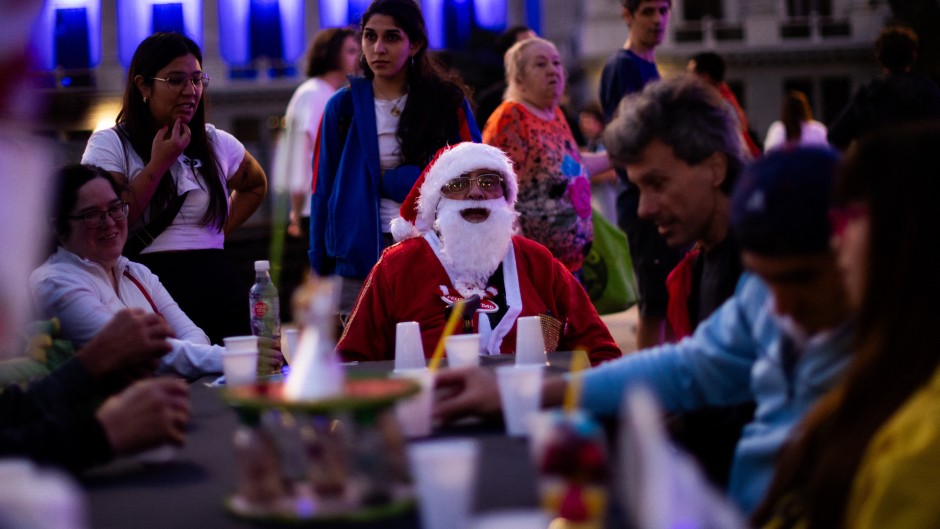 A man dressed as Santa Claus looks on as he takes part in a Christmas solidarity dinner called 'No Families Without Christmas'. AFP/Tomas Cuesta