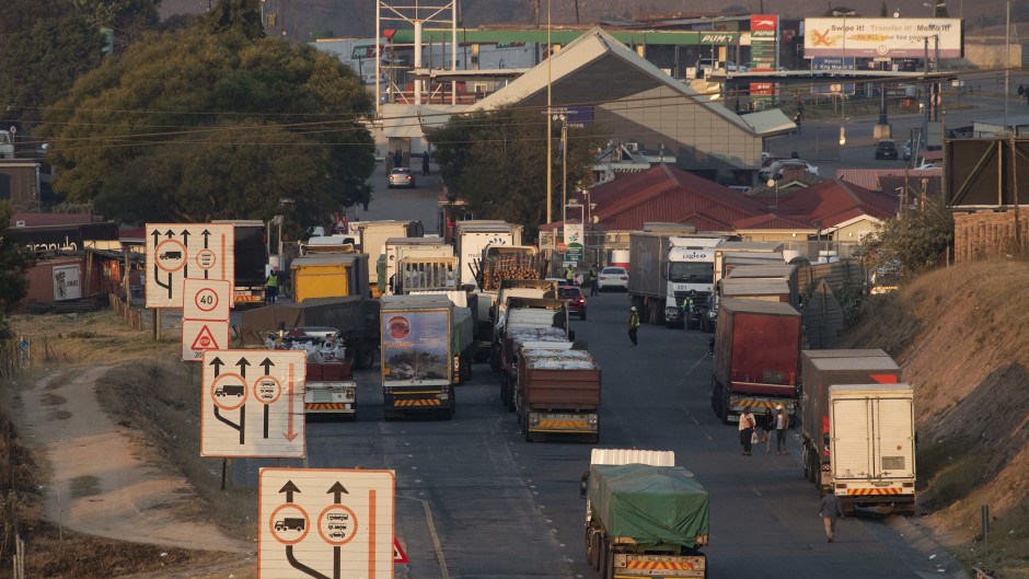 File: Trucks line up outside the Oshoek border-post on the South African side of the border with Eswatini. AFP/Rodger Bosch