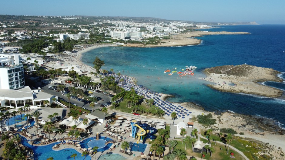 Beachgoers at Nissi Beach in Cyprus' southern coastal resort town of Ayia Napa. AFP/Etienne Torbey