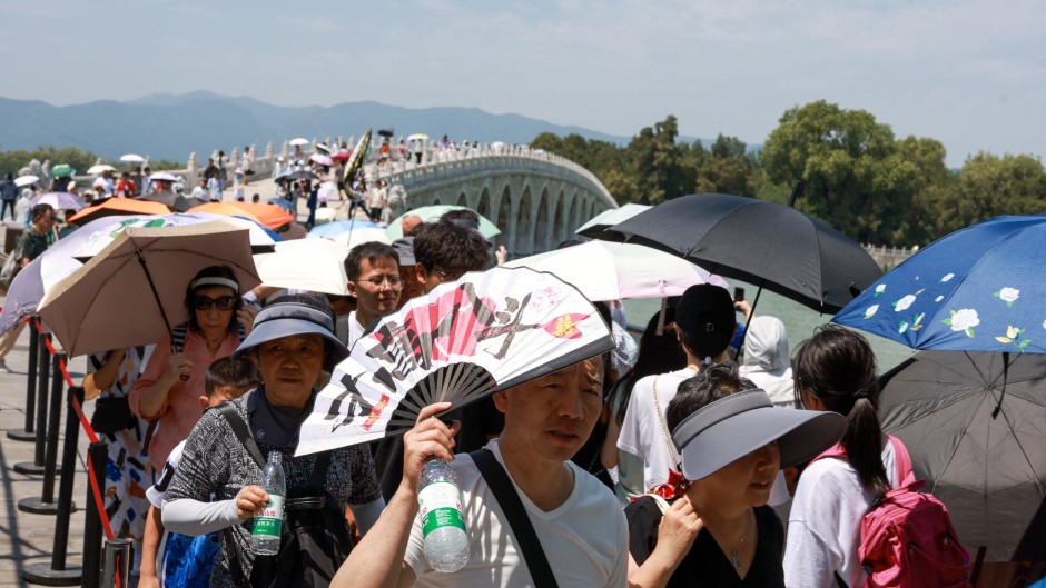 Tourists visit the Summer Palace amid hot weather. Jia Tianyong/cnsphoto/Imaginechina via AFP