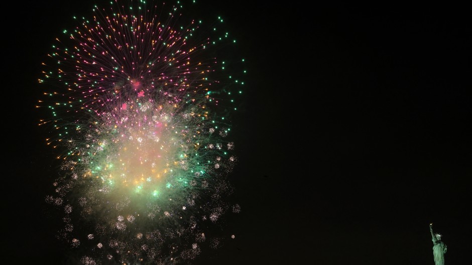 Fireworks celebrating the New Year explode in the sky above the Statue of Liberty, seen from the Red Hook district of New York, on January 1, 2025. 