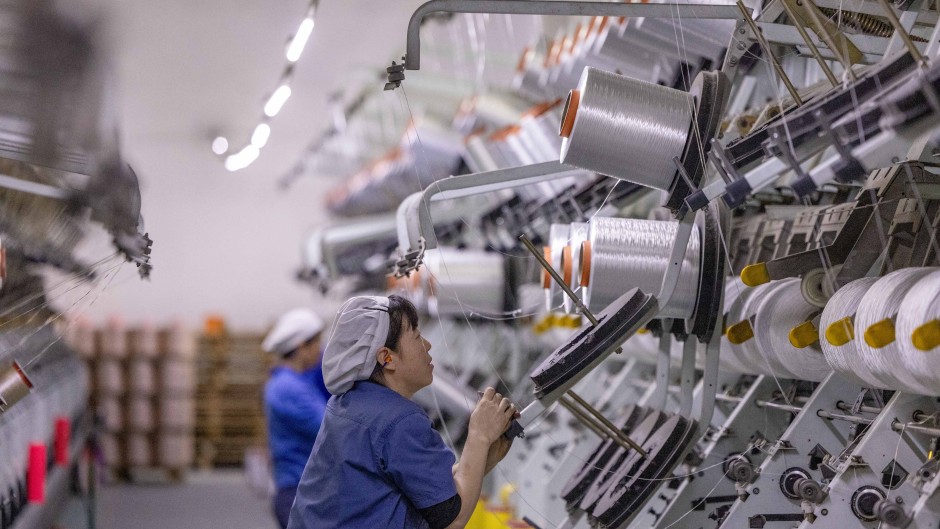 A worker works at a production workshop of Jiangsu Tongxin Chemical Fiber Co LTD. CFOTO/NurPhoto via AFP