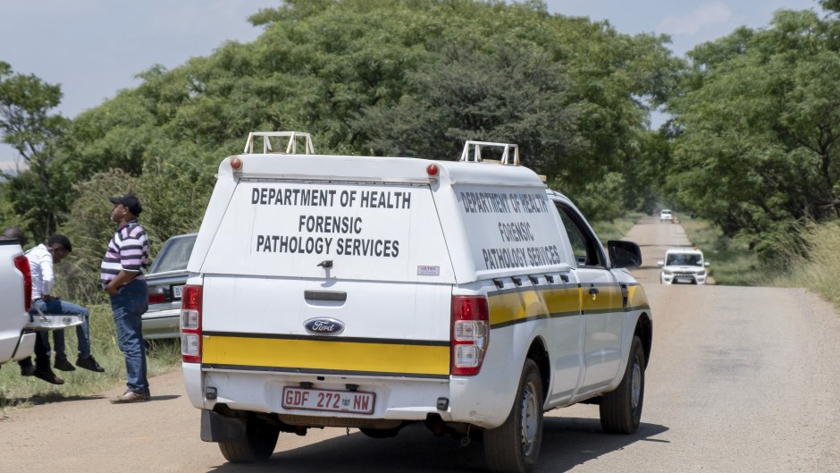 A Forensic Pathology Services car leaves the mining site during a rescue operation to retrieve illegal miners. AFP/Christian Velcich