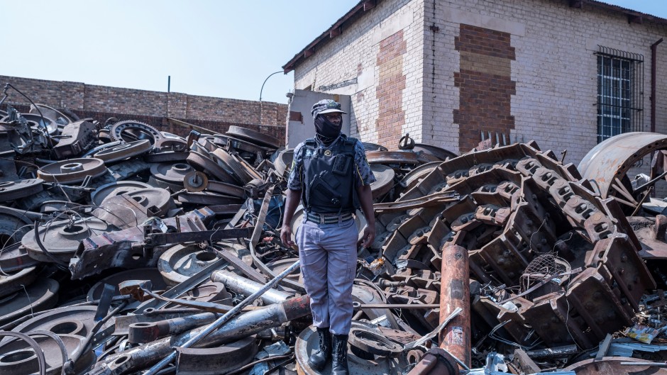 File: A private security guard looks on in a scrapyard during a raid. AFP/Emmanuel Croset