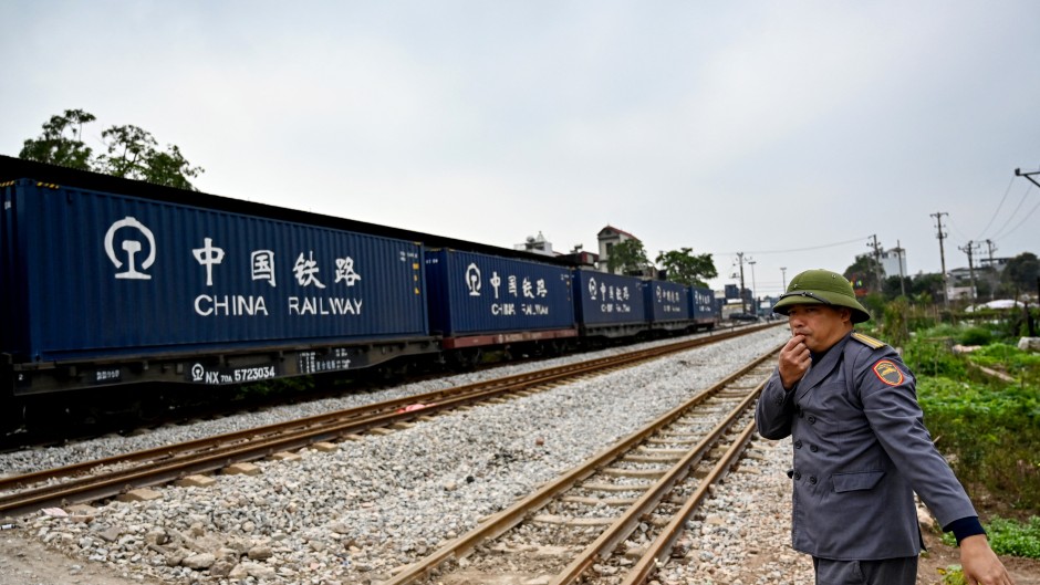 A railway worker guiding a train in Hanoi. AFP/Nhac Nguyen