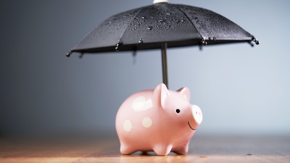 File: A piggy bank with an umbrella. GettyImages/seng kui Lim/500px