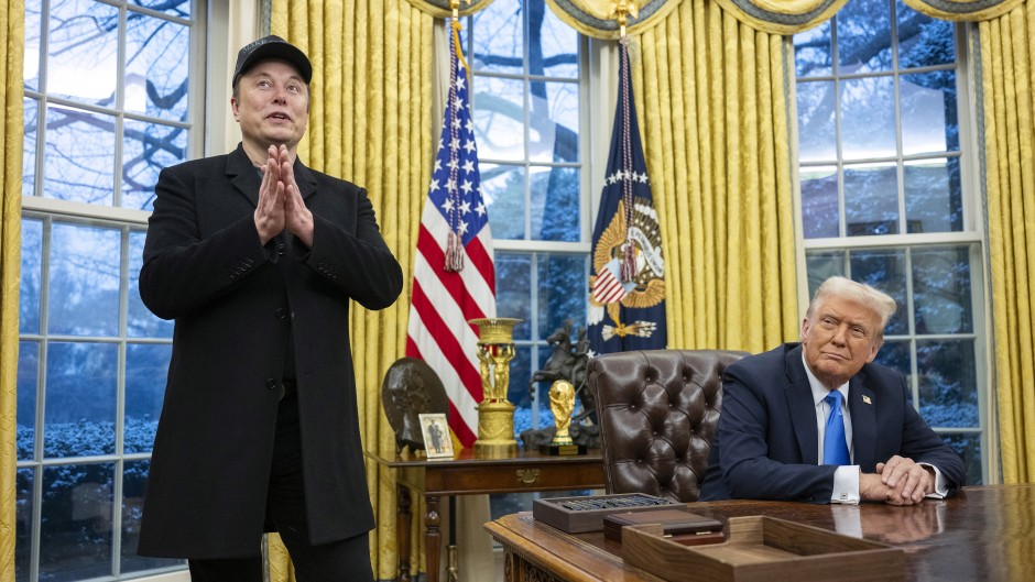 Elon Musk speaks as US President Donald Trump looks on in the Oval Office. AFP/Jim Watson.jpg