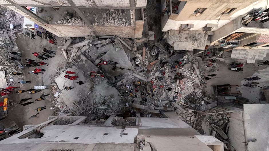 Syrian civil defence members and first responders inspecting the site of an explosion in Syria's western coastal city of Latakia. AFP/SANA