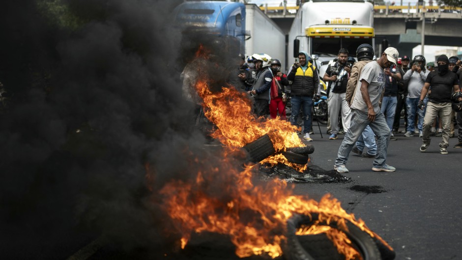 Demonstrators burn tires while blocking a street during a protest against mandatory vehicle insurance in Guatemala City. AFP/Edwin Bercian