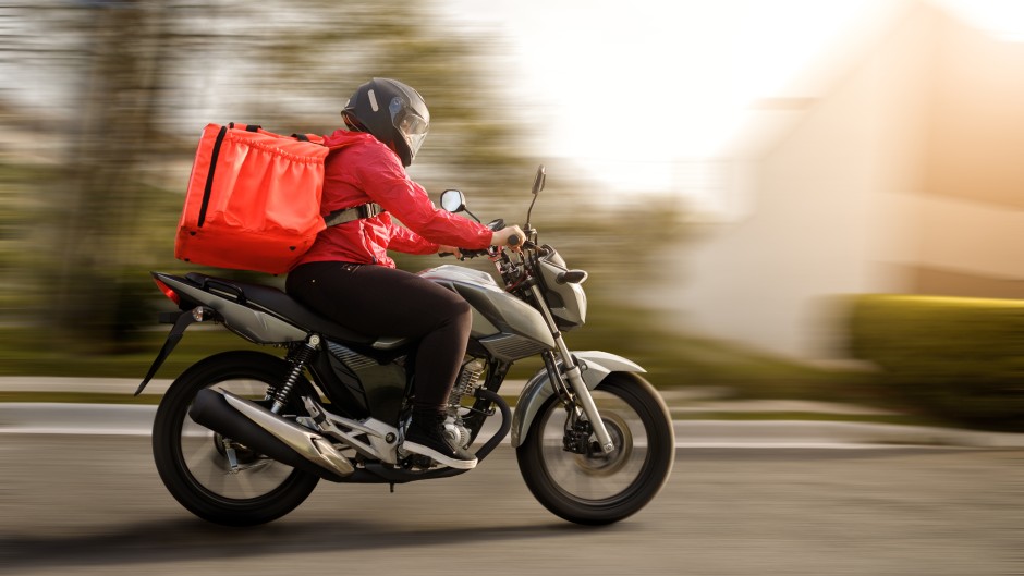 File: A delivery biker on a motorbike. GettyImages/Amanda Caroline da Silva
