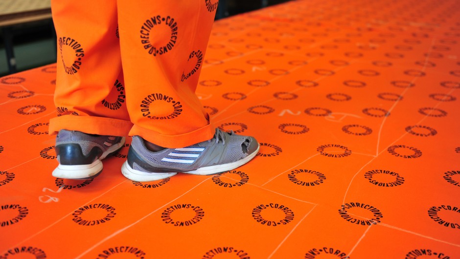 File: A prisoner with Correctional Services printed material. GettyImages/Nigel Jared