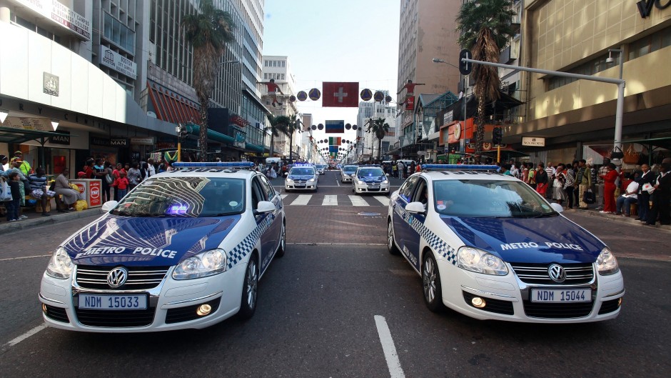 File: Members of the Metro Police drive their cars through to the central streets of Durban. AFP/Rajesh Jantilal