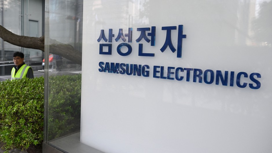 A man walks past the logo of Samsung Electronics displayed outside the company's Seocho building in Seoul. AFP/Jung Yeon-je