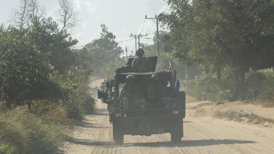 File: A military convoy of South Africa National Defence Forces (SANDF) rides along a dirt road. AFP/Alfredo Zuniga