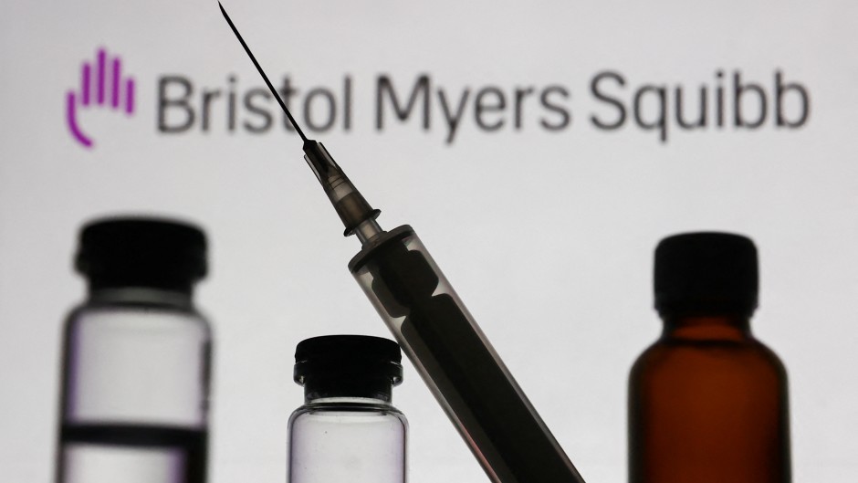 Medical bottles and syringe are seen with Bristol Myers Squibb logo. Jakub Porzycki/NurPhoto via AFP