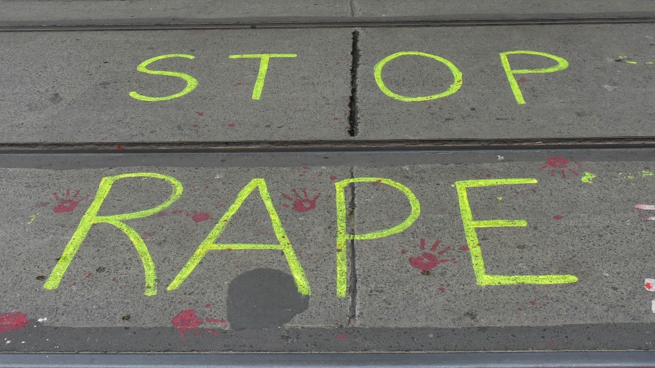 ''Stop rape'' is written on the road by protesters. Debarchan Chatterjee/NurPhoto via AFP