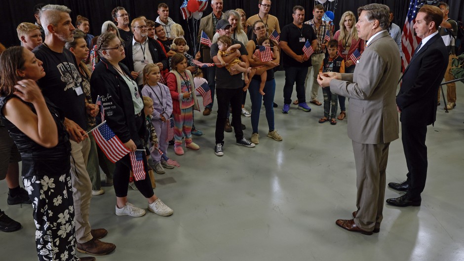 Afrikaners listen to US Deputy Secretary of State Christopher Landau and Homeland Security Deputy Secretary Troy Edgar after arriving in the US. Chip Somodevilla/Getty Images/AFP