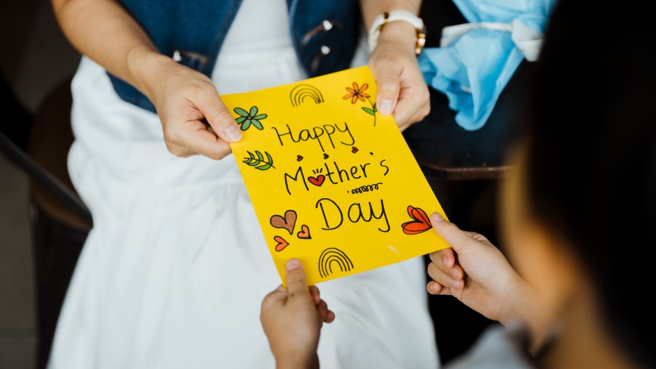 Close-up of woman receiving a Mother's Day card.GettyImages/Chong Kee Siong