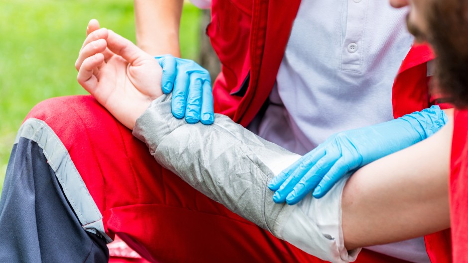 File: A paramedic treating burns on a victim's arm. GettyImages/microgen