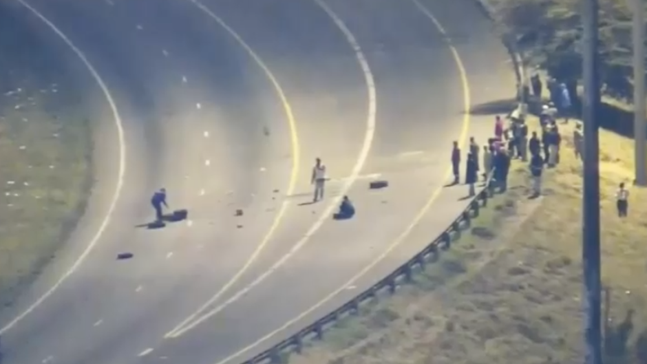 Protesters placing objects on the road.