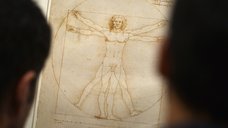 People look at the "Vitruvian Man" a drawing by Leonardo da Vinci. AFP/Gabriel Bouys