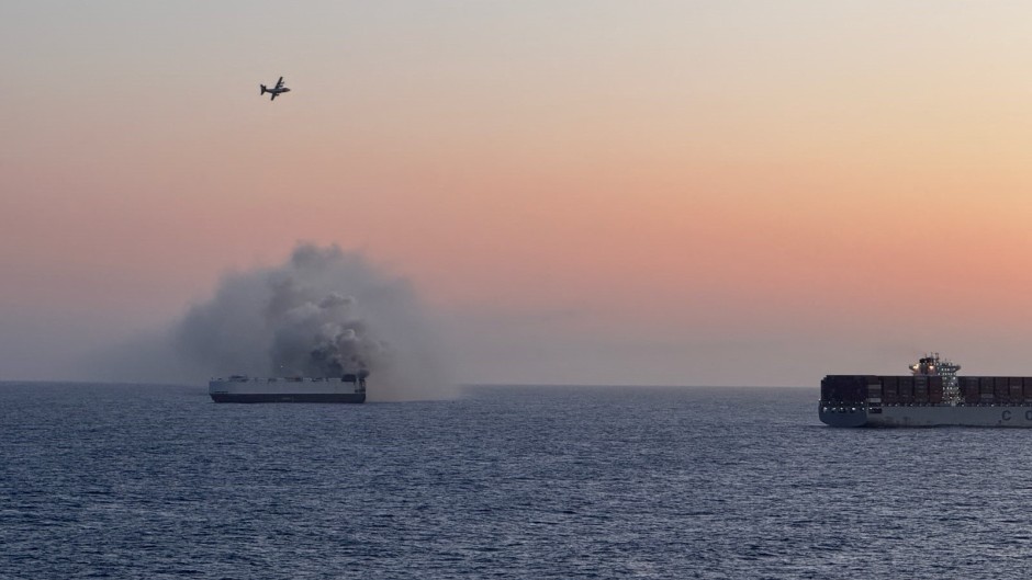 All 22 crew members were rescued by the crew of motor vessel Cosco Hellas with no reported injuries. US Coast Guard/Courtesy of Roland Hobson/AFP