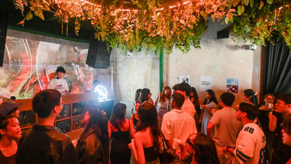 Attendees listening to music while drinking coffee at an alcohol-free clubbing event in Singapore. AFP/Roslan Rahman