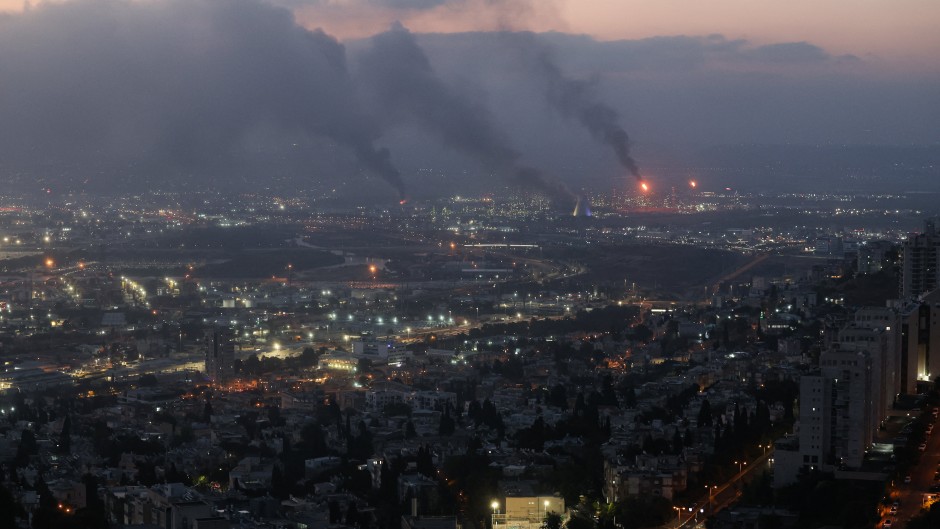 Smoke billows from a site in the city of Haifa following a fresh barrage of Iranian missiles. AFP/Ahmad Gharabli