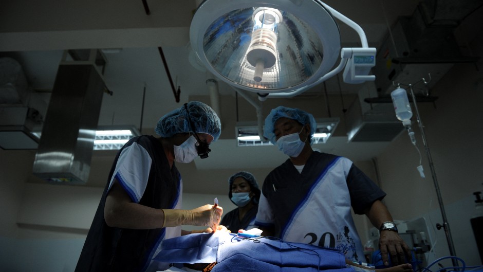 File: Doctors are pictured in the operating theatre as they perform surgery. AFP/Noel Celis