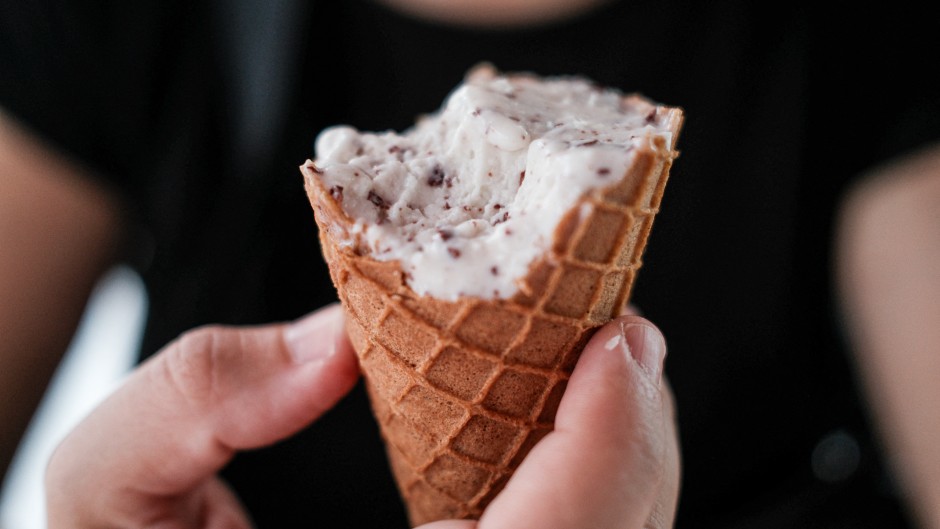 A hand holding a half-melted ice cream. Romain Costaseca/Hans Lucas via AFP