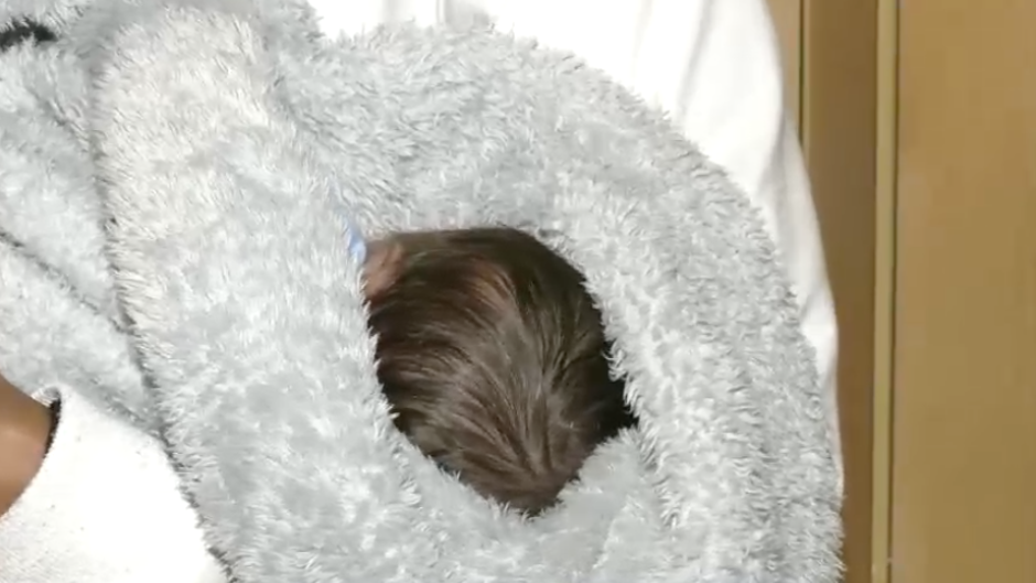 Baby Mogamat fast asleep in his mother's arms.