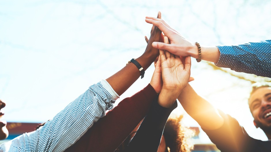a high five with a diverse a group of people 