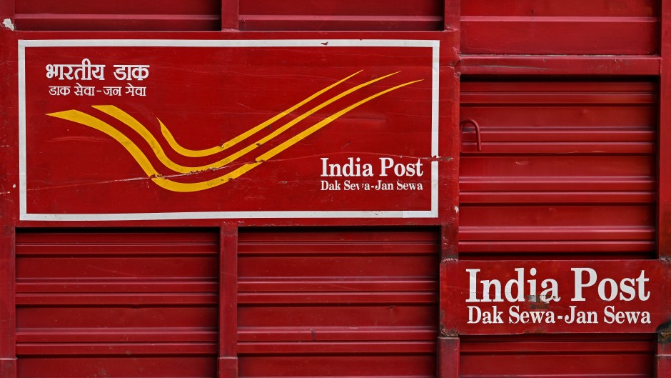 An India Post vehicle is pictured along a road in New Delhi. AFP/Sajjad Hussain