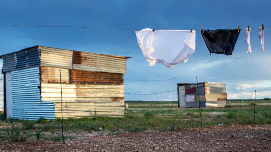 File: A school uniform hangs among shacks. GettyImages/Per-Anders Pettersson