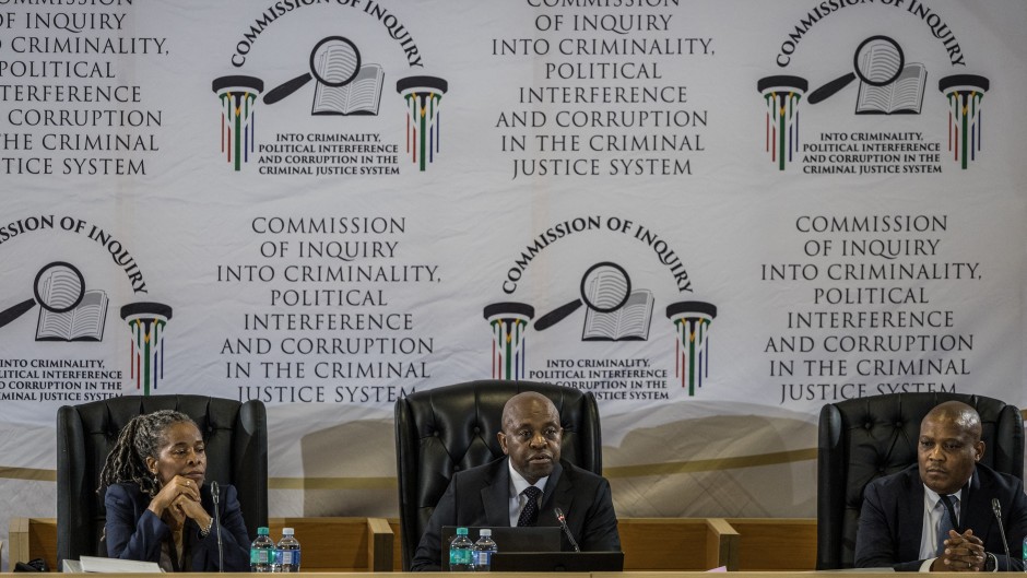 Justice Mbuyiseni Madlanga delivers his remarks during the judicial commission of inquiry probing Provincial Police Commissioner Nhlanhla Mkhwanazi's claims. AFP/Phill Magakoe
